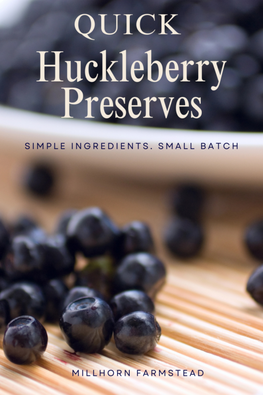 Wild huckleberries in a bowl and scattered on a wooden surface for homemade huckleberry preserves.